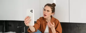 The featured image contains a lady holding an iPhone 15